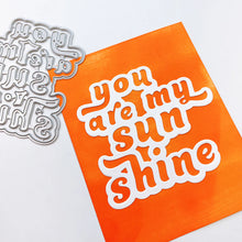 Load image into Gallery viewer, Catherine Pooler - Layered Word Dies - My Sunshine. This word die cuts a frame for the phrase "you are my sunshine" that can be used open or with the letters inlaid back inside for more color contrast. Available at Embellish Away located in Bowmanville Ontario Canada. Example by Catherine Pooler Designs.