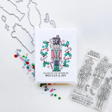 Cargar imagen en el visor de la galería, Catherine Pooler - Stamp & Die Set - Nutcracker Sweet. Meet the cutest nutcrackers in town! This whimsical set features charming nutcrackers adorned in a delightful array of sweets and treats, including cupcakes, candy canes, and figgy pudding. Available at Embellish Away located in Bowmanville Ontario Canada. Example by Catherine Pooler Designs.