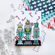 Cargar imagen en el visor de la galería, Catherine Pooler - Stamp & Die Set - Nutcracker Sweet. Meet the cutest nutcrackers in town! This whimsical set features charming nutcrackers adorned in a delightful array of sweets and treats, including cupcakes, candy canes, and figgy pudding. Available at Embellish Away located in Bowmanville Ontario Canada. Example by Catherine Pooler Designs.