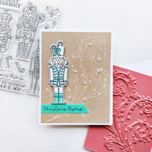 Cargar imagen en el visor de la galería, Catherine Pooler - Stamp & Die Set - Nutcracker Sweet. Meet the cutest nutcrackers in town! This whimsical set features charming nutcrackers adorned in a delightful array of sweets and treats, including cupcakes, candy canes, and figgy pudding. Available at Embellish Away located in Bowmanville Ontario Canada. Example by Catherine Pooler Designs.
