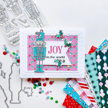 Cargar imagen en el visor de la galería, Catherine Pooler - Stamp & Die Set - Nutcracker Sweet. Meet the cutest nutcrackers in town! This whimsical set features charming nutcrackers adorned in a delightful array of sweets and treats, including cupcakes, candy canes, and figgy pudding. Available at Embellish Away located in Bowmanville Ontario Canada. Example by Catherine Pooler Designs.