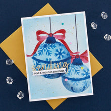Load image into Gallery viewer, Spellbinders - Stencil By Bibi Cameron Snowflakes - Snowflake Ornaments. Snowflake Ornaments Stencil is part of the Bibi's Snowflakes Collection by Bibi Cameron and comes in a set of two 6 x 9-inch layering stencils and two masks. Available at Embellish Away located in Bowmanville Ontario Canada. Example by brand ambassador.