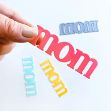 Load image into Gallery viewer, Catherine Pooler - Word Die - Just Mom. Send a card to your favorite mom! The Just Mom Word Die is a simple block font "mom" that will be a cute addition to any card for mother's day or any day celebrating your best lady! Take the "m" and cut one hump off to create "mum"! The Mom Word Die measures approx. 3" x 1". Illustrated by Lisa Kirkbride. Available at Embellish Away located in Bowmanville Ontario Canada.