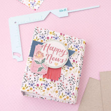 Cargar imagen en el visor de la galería, We R Memory - Book Cover Guide - Mint. Perfect book board placement, consistent gaps, trim corners at the proper angle, easily round corners and mark spot for elastic closure. It also includes a scan code for detailed instructions. Available at Embellish Away located in Bowmanville Ontario Canada.