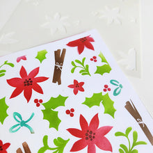 Load image into Gallery viewer, Catherine Pooler - Layered Stencil - Holiday Mix. Featuring a charming pattern of poinsettias, holly, and cinnamon bundles, it’s perfect for ink blending your favorite color combinations. Available at Embellish Away located in Bowmanville Ontario Canada.
