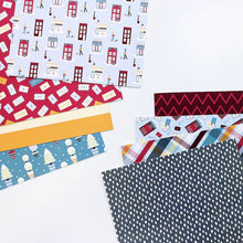 Load image into Gallery viewer, Catherine Pooler - Patterned Paper - Bedford Falls. This paper pack features patterns and prints of life in a sleepy little town. Featuring a print of houses and people out walking their dogs along with post boxes, letters, and snow topped topiaries! Available at Embellish Away located in Bowmanville Ontario Canada.

