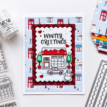 Load image into Gallery viewer, Catherine Pooler - Patterned Paper - Bedford Falls. This paper pack features patterns and prints of life in a sleepy little town. Featuring a print of houses and people out walking their dogs along with post boxes, letters, and snow topped topiaries! Available at Embellish Away located in Bowmanville Ontario Canada. Example by brand ambassador.
