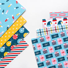 Cargar imagen en el visor de la galería, Catherine Pooler - Patterned Paper - Holiday De-Lights. When trimming the tree, don't forget the holiday de-lights! The Holiday De-Lights Patterned Paper is a quintessential holiday mix of patterns and prints! Available at Embellish Away located in Bowmanville Ontario Canada.
