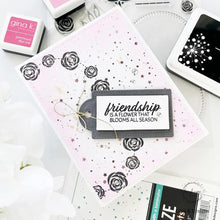 Load image into Gallery viewer, Gina K. Designs - Stamp &amp; Die Set - Friendship Blooms. Friendship Blooms is a stamp &amp; die set by Lisa Hetrick. This set is made of premium clear photopolymer and measures 6" X 8".  Made in the USA. Available at Embellish Away located in Bowmanville Ontario Canada. Example by brand ambassador.
