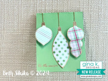 Load image into Gallery viewer, Gina K. Designs - Stamp &amp; Die Set - Holiday Ornaments. Holiday Ornaments is a stamp set by Beth Silaika. This set is made of premium clear photopolymer and measures 6" X 8". Made in the USA. Available at Embellish Away located in Bowmanville Ontario Canada. Card example by Beth Silaika.
