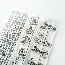 Cargar imagen en el visor de la galería, Catherine Pooler - Stamp - Backyard Borders. Color the images in the Backyard Borders Stamp Set as a focal point on your card, or use them as a subtle background. The Backyard Borders Stamp set includes a row of fence posts, singing birds, and planted veggies. Available at Away in Bowmanville Ontario Canada.
