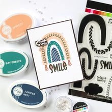 Load image into Gallery viewer, Catherine Pooler - Stamp &amp; Dies Set - Smile Bright. Smile Bright! This 6x8 Stamp Set and coordinating dies are ready for you to piece it together to your hearts content to create a modern, boho rainbow. Available at Embellish Away located in Bowmanville Ontario Canada. Card example by brand ambassador.
