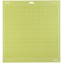 Charger l'image dans la galerie, Cricut - Cutting Mats 12"X12" - 2/Pkg - StandardGrip. This multi-purpose mat is perfect for a wide range of medium weight materials: patterned paper, vinyl, iron-on and cardstock. This package contains two 12x12 inch standard grip cutting mat. Imported. Available at Embellish Away located in Bowmanville Ontario Canada.
