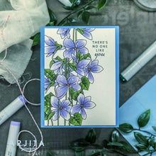 Load image into Gallery viewer, Gina K. Designs - Stamp &amp; Die Set - Blue Violets. Blue Violet is a stamp set by Arjita Singh. This set is made of premium clear photopolymer and measures 6" X 8". The die set gives you the ability to cut out and layer, creating texture to your creation. Available at Embellish Away located in Bowmanville Ontario Canada. Example by brand ambassador.
