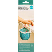 गैलरी व्यूवर में इमेज लोड करें, We R Memory Keepers - Desktop Dustbin. Keep your crafting space clean with the Desktop Dustbin from We R Memory Keepers. This handy little litter-catcher is perfect for decluttering after a long day of crafting. The adjustable clamps fit on most desks and work surfaces to accommodate any space, and this makes it easy to scoop and sweep up glitter and paper scraps from your work area. Available at Embellish Away located in Bowmanville Ontario Canada.
