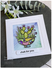 Charger l'image dans la galerie, Woodware - 4"x4" Clear Singles Stamp - Succulent Display. On trend stamp with a pot filled with succulents the pot is calling out to be coloured in hot desert colours. Add a personal touch with your favourite colouring medium and the fun words. Designed by Francoise Read. These stamps would be perfect for cards and scrapbook pages as well as mixed media or fun décor projects. Available at Embellish Away located in Bowmanville Ontario Canada. Card design by Debbie Smith
